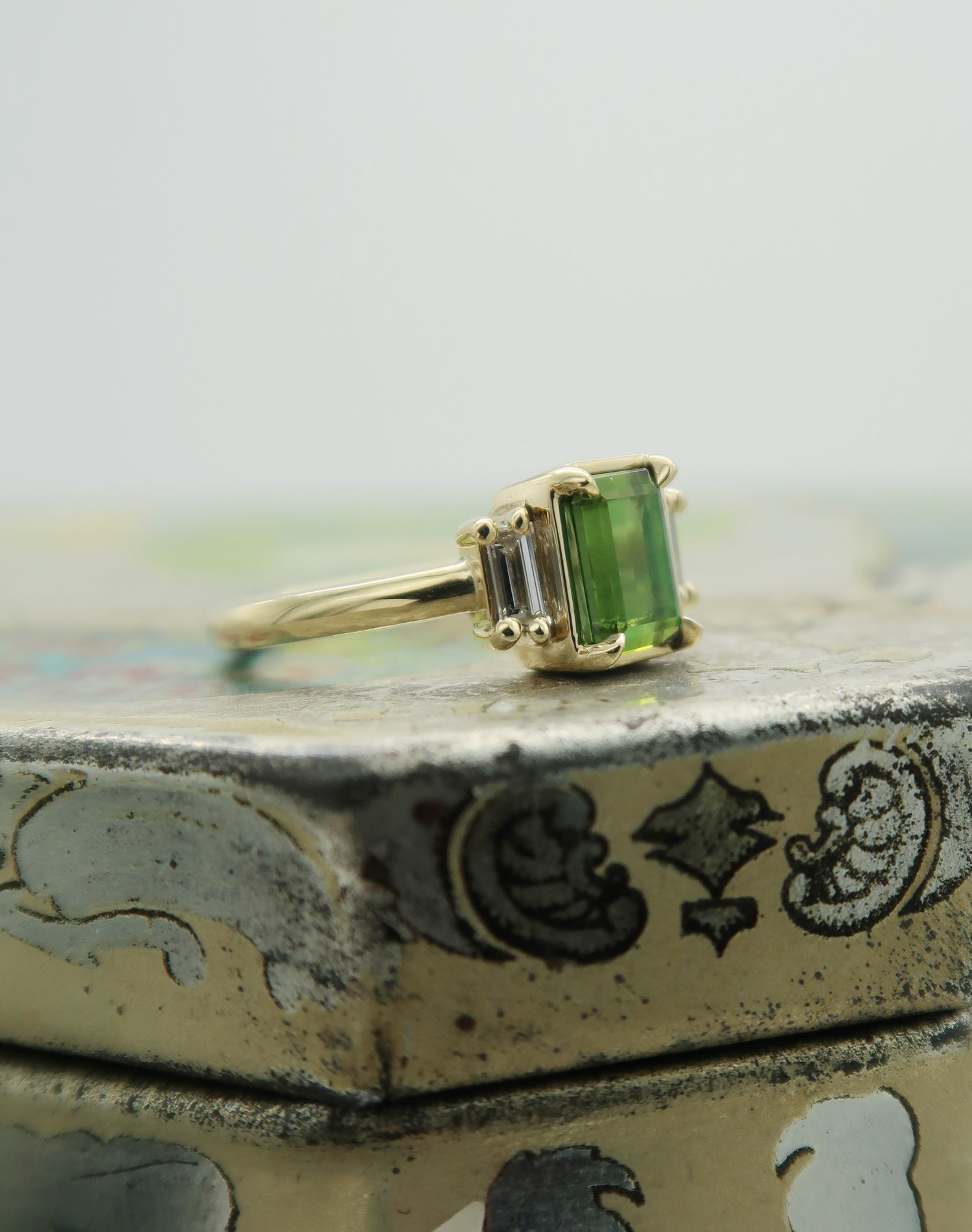 10k Yellow Green Tourmaline Ring with Baguette Diamond Accents.  Shown from the side.