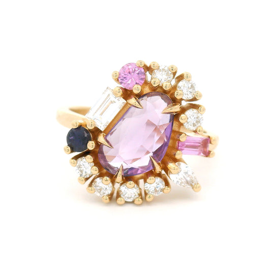 14K yellow gold asymmetrical engagement ring featuring a natural 1.01ct triangular purple sapphire with a halo of mixed-cut pink and purple sapphires and lab-grown diamonds totalling 0.93cts.