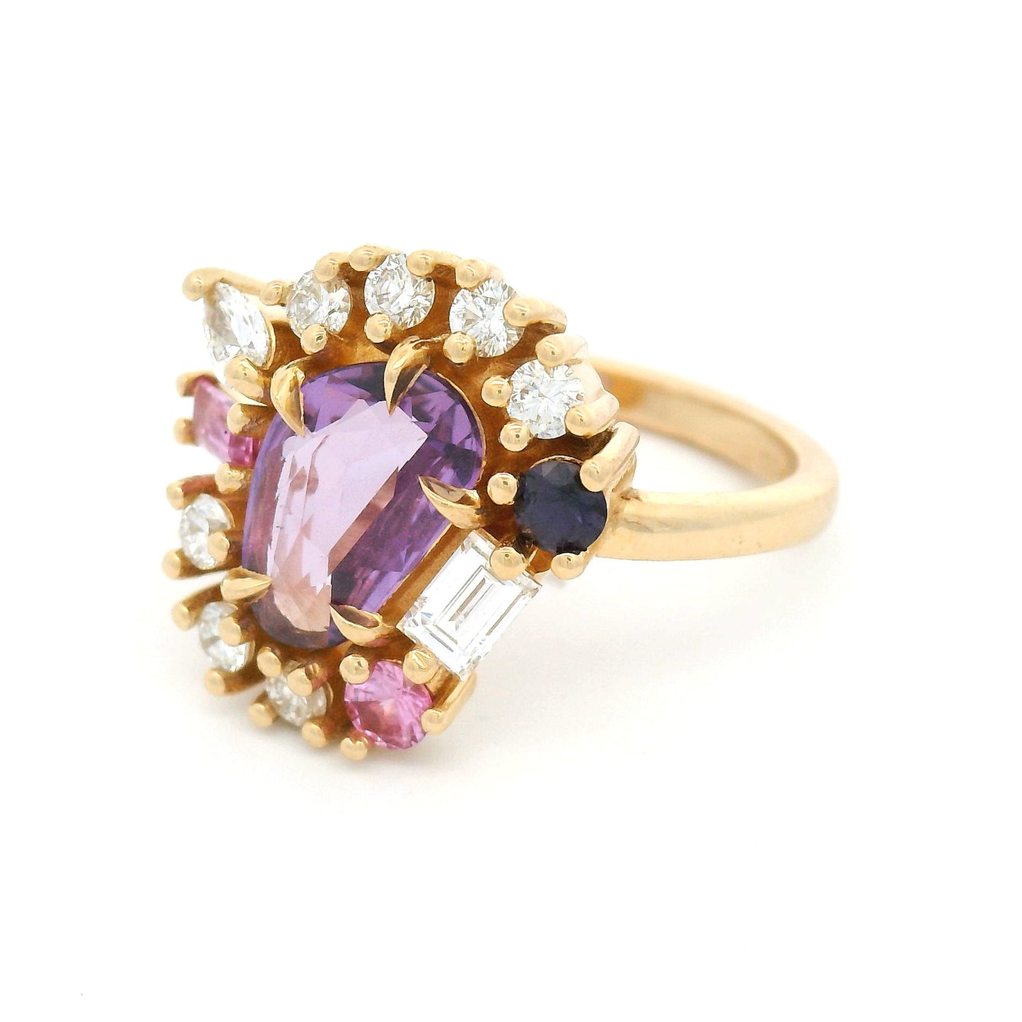 14K yellow gold asymmetrical engagement ring featuring a natural 1.01ct triangular purple sapphire with a halo of mixed-cut pink and purple sapphires and lab-grown diamonds totalling 0.93cts.