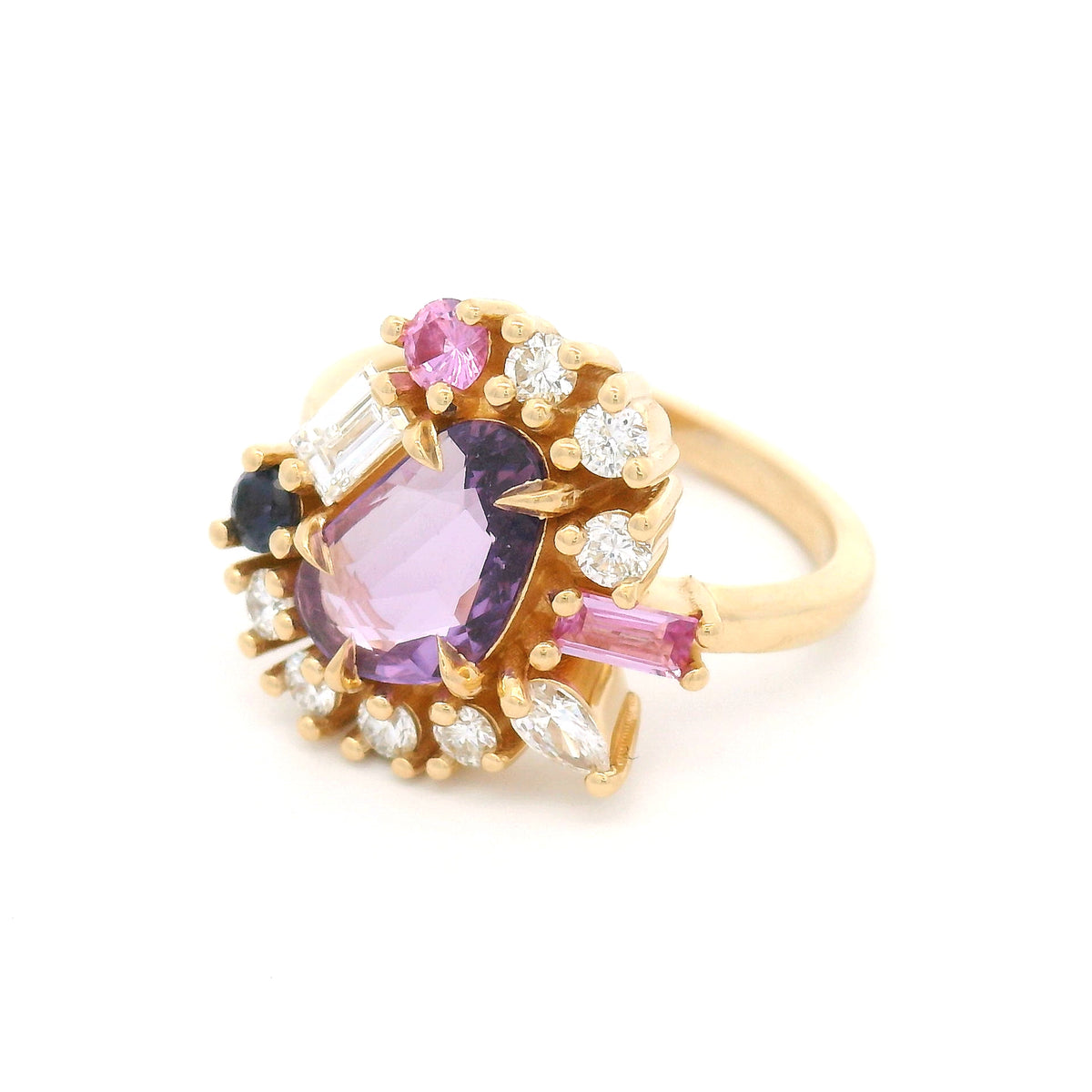 14K yellow gold asymmetrical engagement ring featuring a natural 1.01ct triangular purple sapphire with a halo of mixed-cut pink and purple sapphires and lab-grown diamonds totalling 0.93cts.