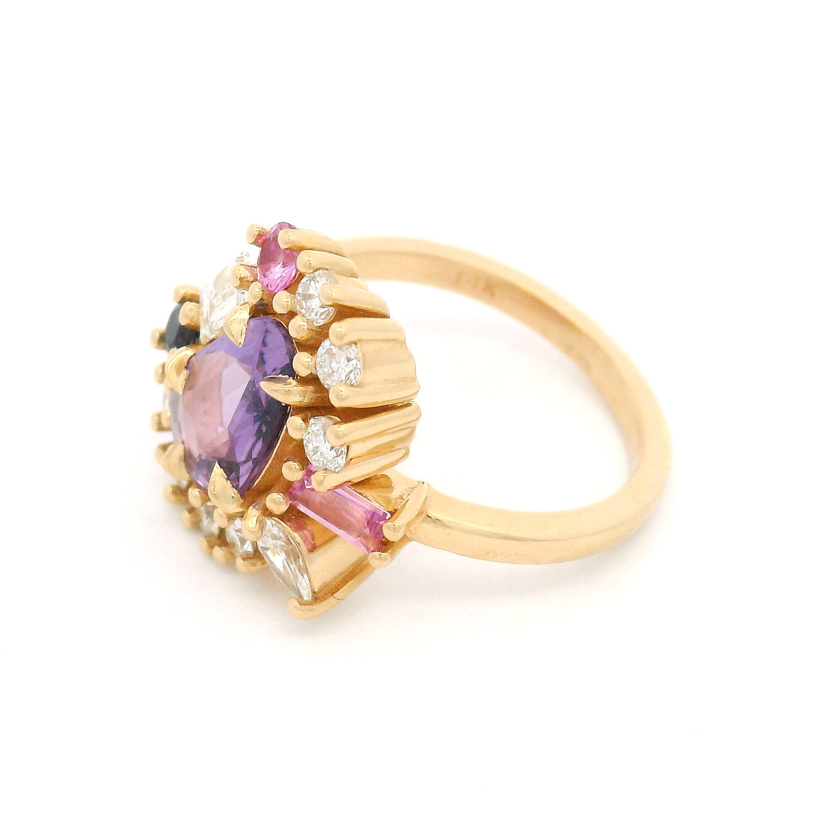 14K yellow gold asymmetrical engagement ring featuring a natural 1.01ct triangular purple sapphire with a halo of mixed-cut pink and purple sapphires and lab-grown diamonds totalling 0.93cts.