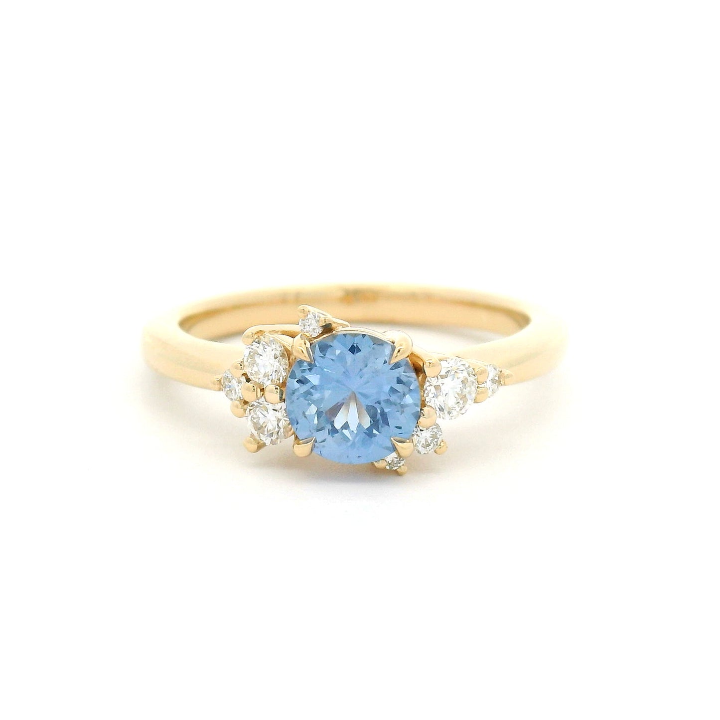 14K yellow gold engagement ring with a natural 0.82ct unheated round Sri Lankan cornflower blue sapphire and asymmetrical scatter of eight natural diamonds.