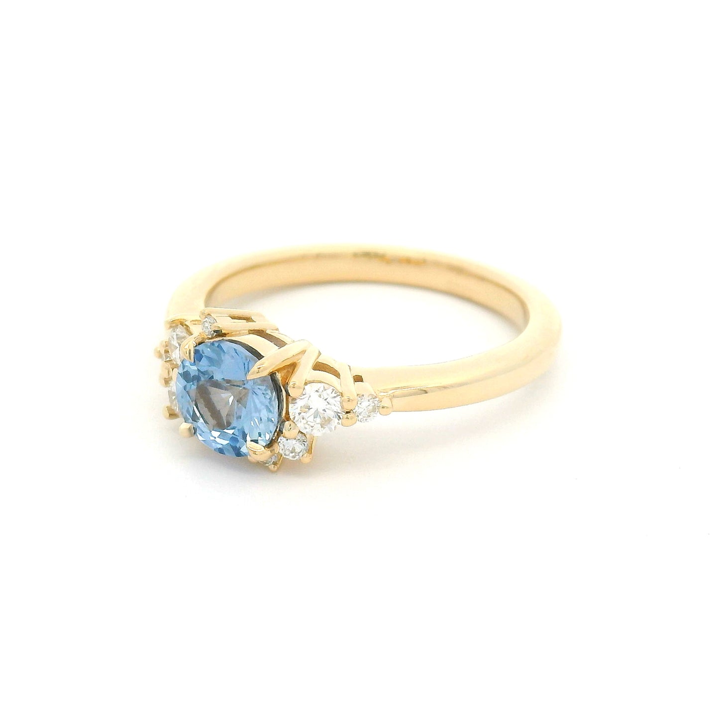 14K yellow gold engagement ring with a natural 0.82ct unheated round Sri Lankan cornflower blue sapphire and asymmetrical scatter of eight natural diamonds.
