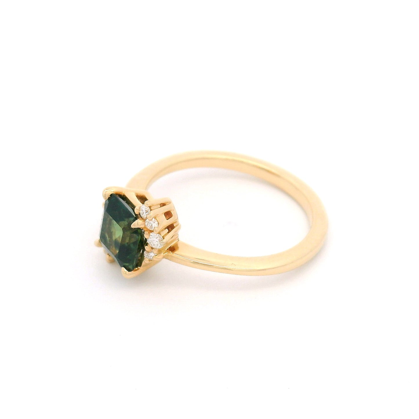 14K yellow gold asymmetrical engagement ring featuring a claw-set natural 1.41ct square radiant-cut dark green-teal sapphire with 10 claw-set natural diamond accents totalling 0.16cts on a delicate 1.7mm band.