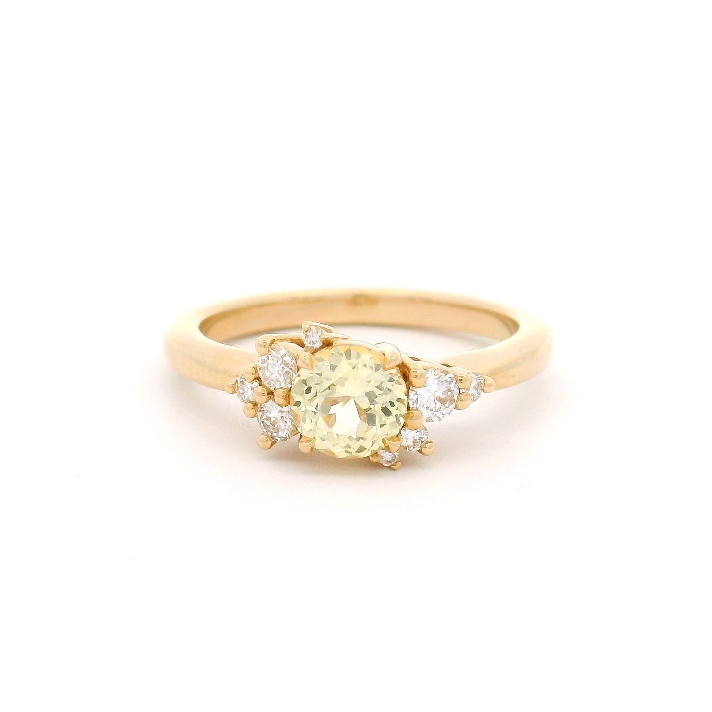 14K yellow gold engagement ring featuring a claw-set natural 0.83ct round mixed-cut yellow sapphire accented by eight claw-set natural round brilliant-cut diamonds totalling 0.22cts.