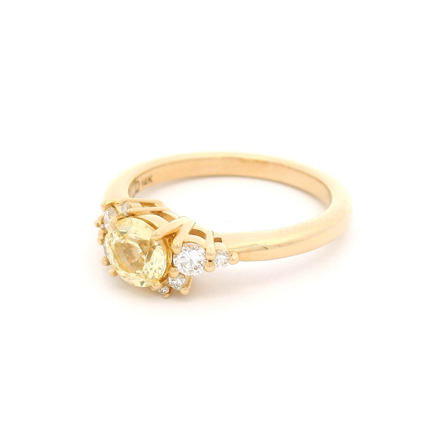 14K yellow gold engagement ring featuring a claw-set natural 0.83ct round mixed-cut yellow sapphire accented by eight claw-set natural round brilliant-cut diamonds totalling 0.22cts.
