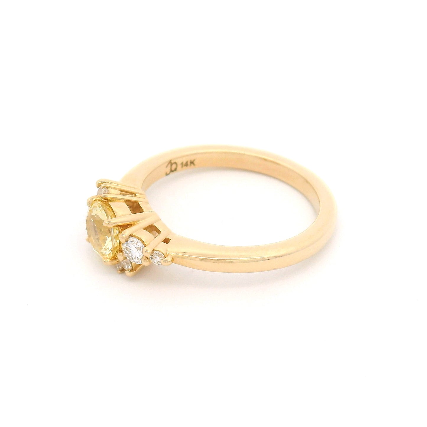 14K yellow gold engagement ring featuring a claw-set natural 0.83ct round mixed-cut yellow sapphire accented by eight claw-set natural round brilliant-cut diamonds totalling 0.22cts.