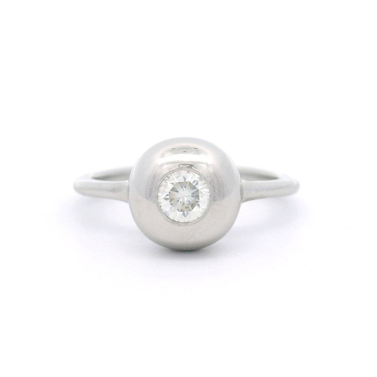 Platinum bezel-set solitaire ring with a natural 0.30ct round brilliant-cut diamond, I1 clarity, K colour, rounded dome and 1.5mm band.