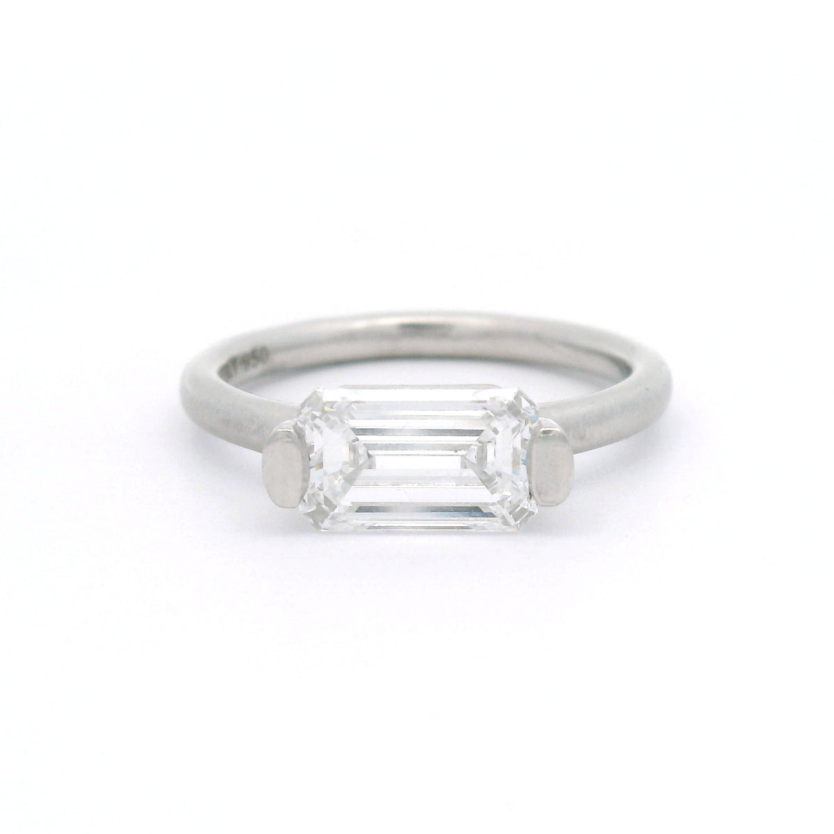 Platinum bar-set solitaire engagement ring with a 1.58ct lab-grown emerald-cut diamond, VVS1 clarity, D colour and rounded 2mm satin band.