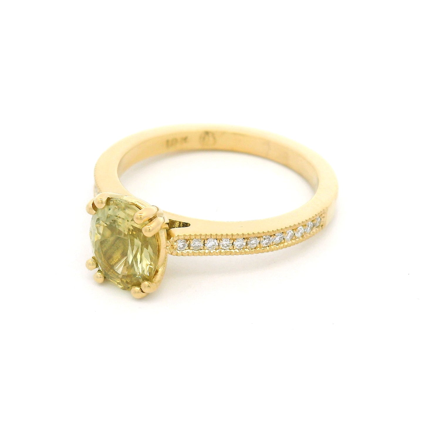 18K yellow gold engagement ring with a double claw-set 1.49ct natural oval yellow sapphire, bead-set natural diamond shoulders, and milgrain edges.