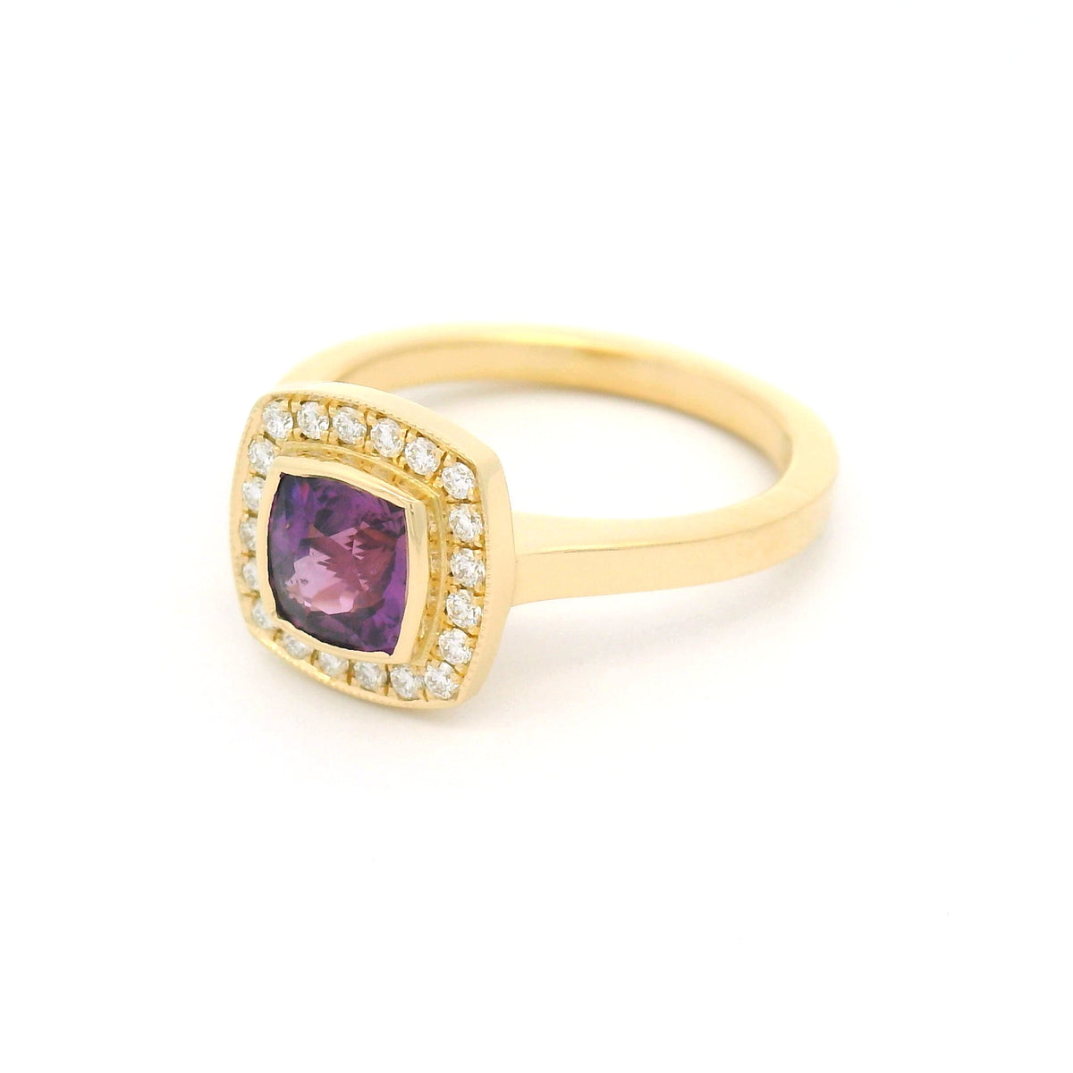 18K yellow gold bezel-set engagement ring with a natural 1.28ct purple square cushion-cut sapphire, 20 natural diamonds, milgrain halo border and flush-fit design.
