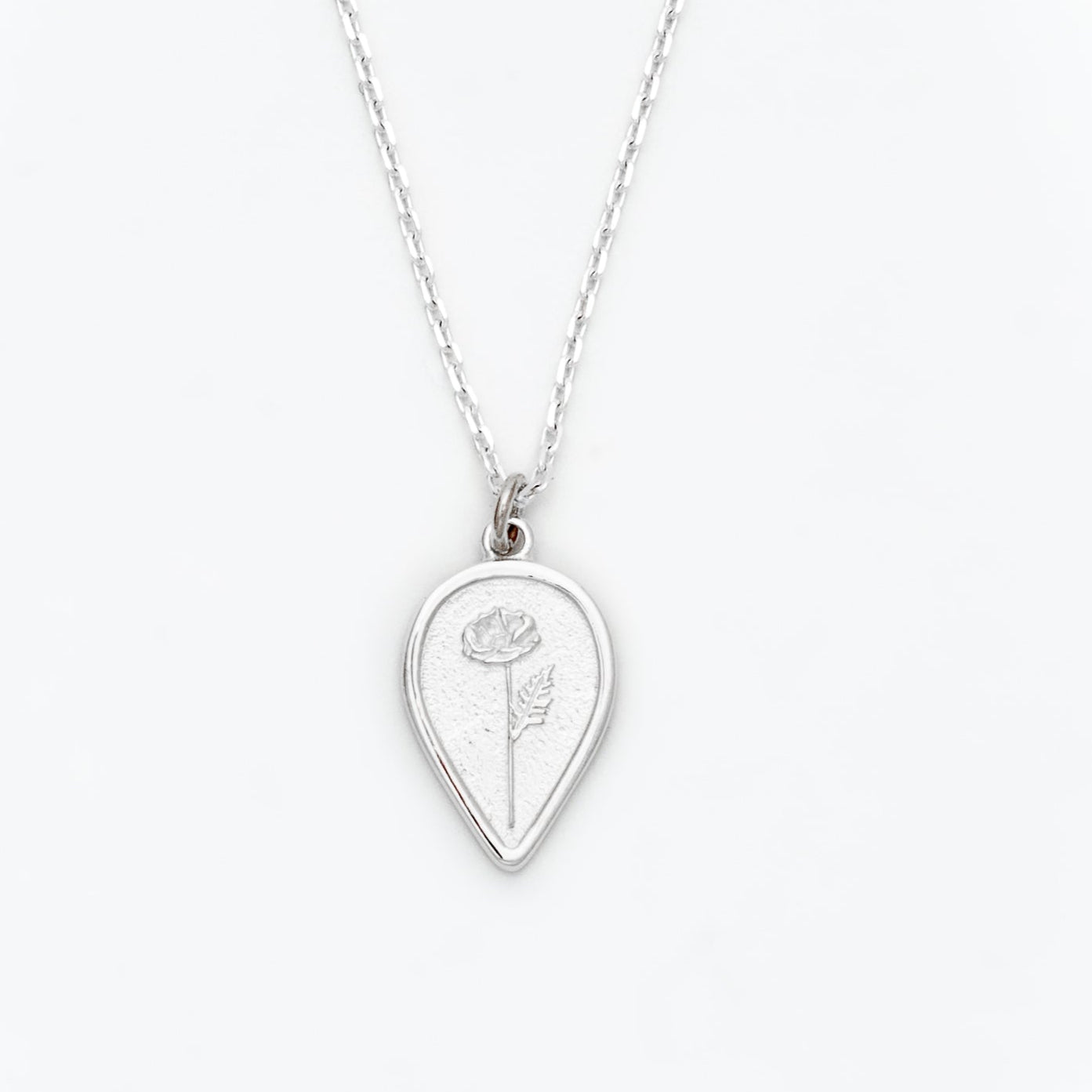 Silver necklace with a teardrop-shaped pendant featuring