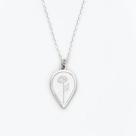 Silver necklace with a teardrop-shaped pendant featuring