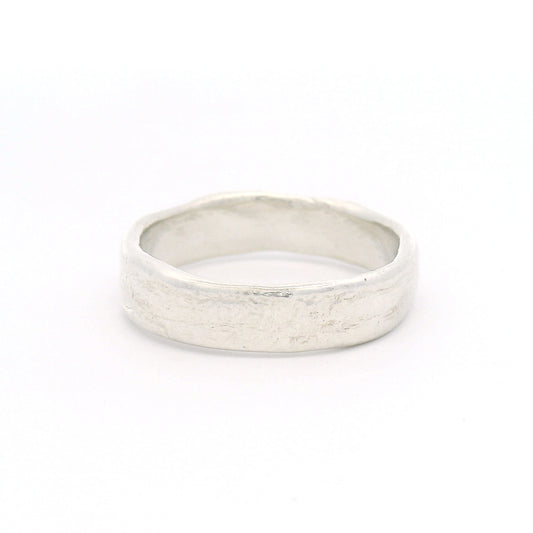 Sterling silver 5.5mm wedding band featuring a soft organic texture, gently domed profile, and comfort-fit interior.