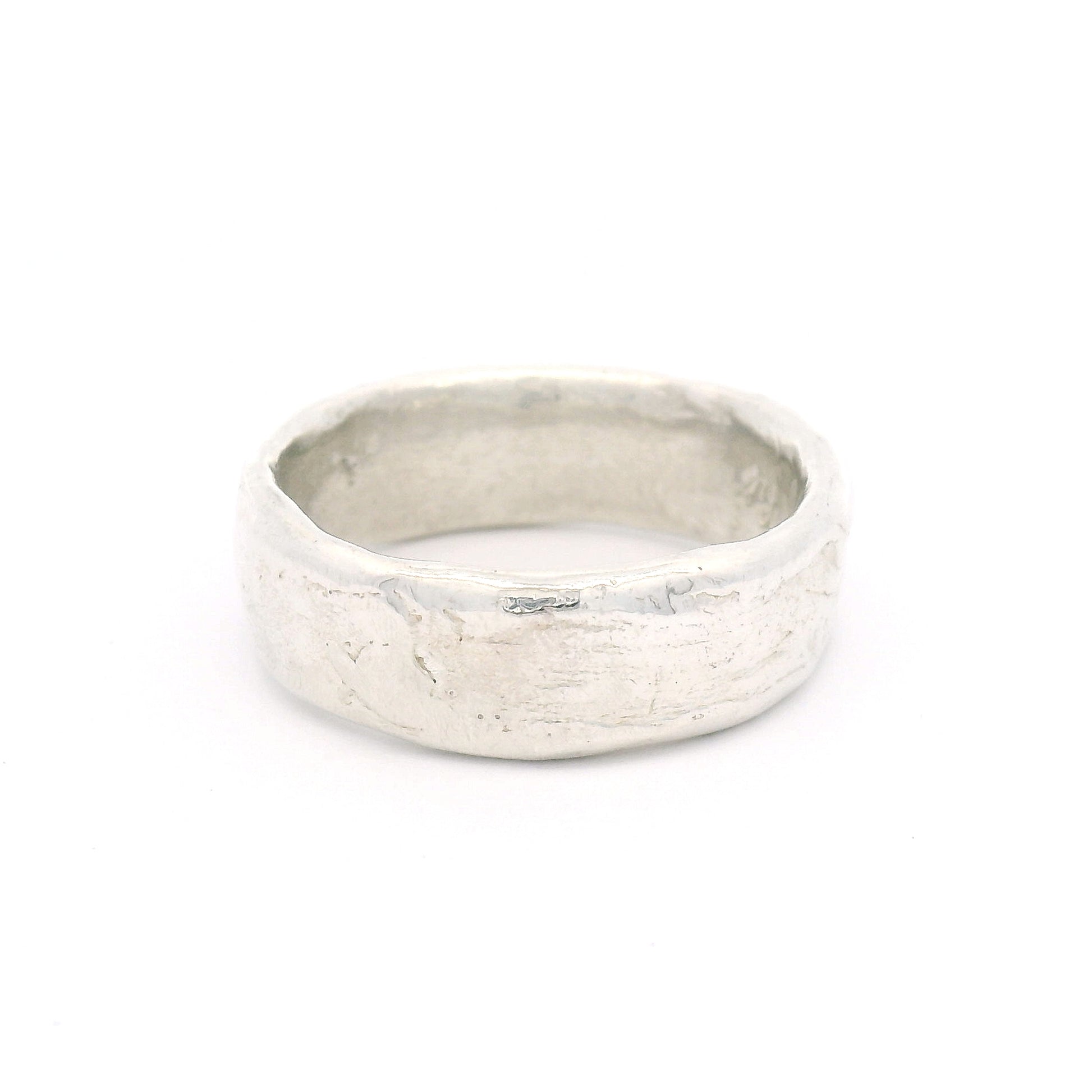 Sterling silver 7.5mm wedding band featuring a soft organic texture, gently domed profile, and comfort-fit interior.
