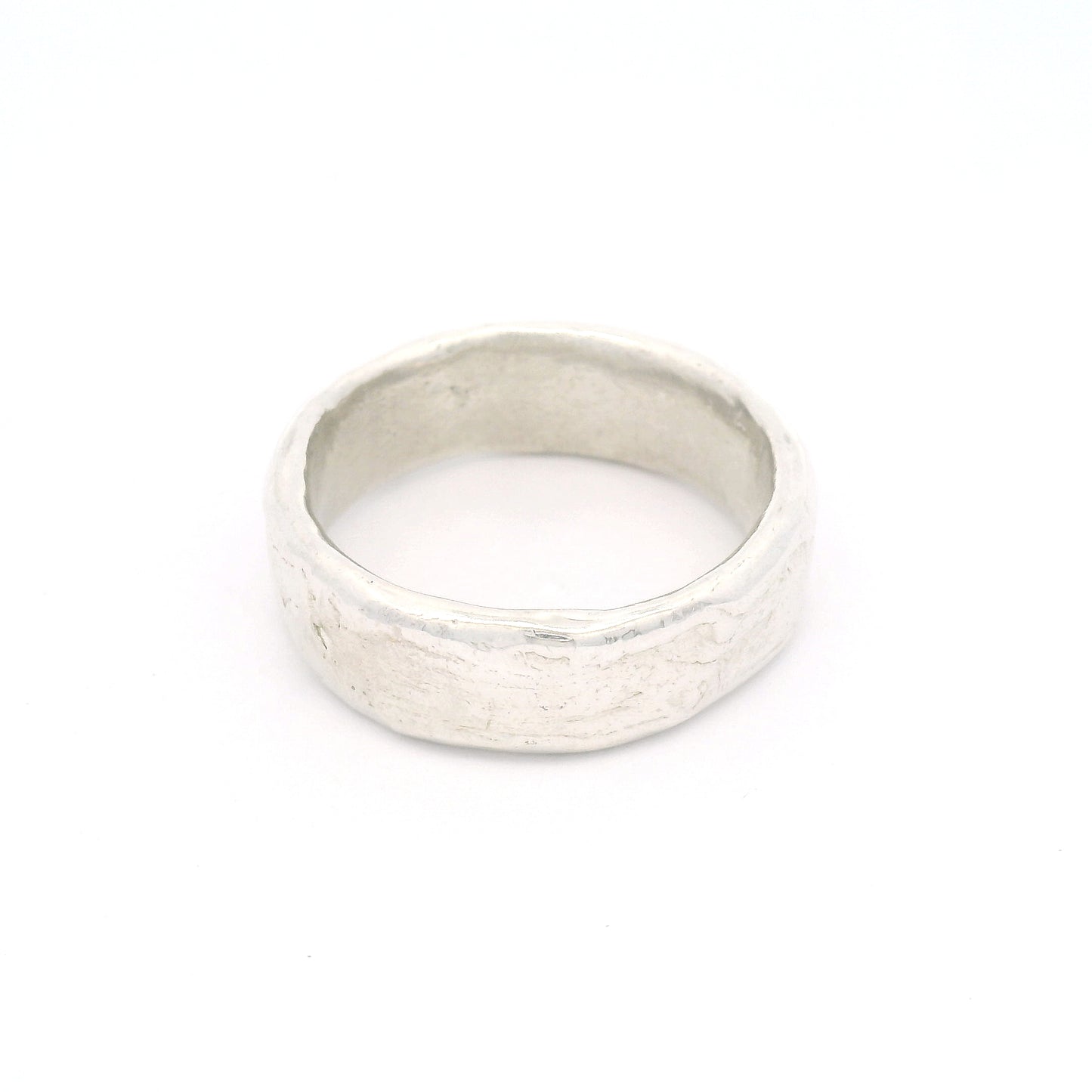 Sterling silver 7.5mm wedding band featuring a soft organic texture, gently domed profile, and comfort-fit interior.