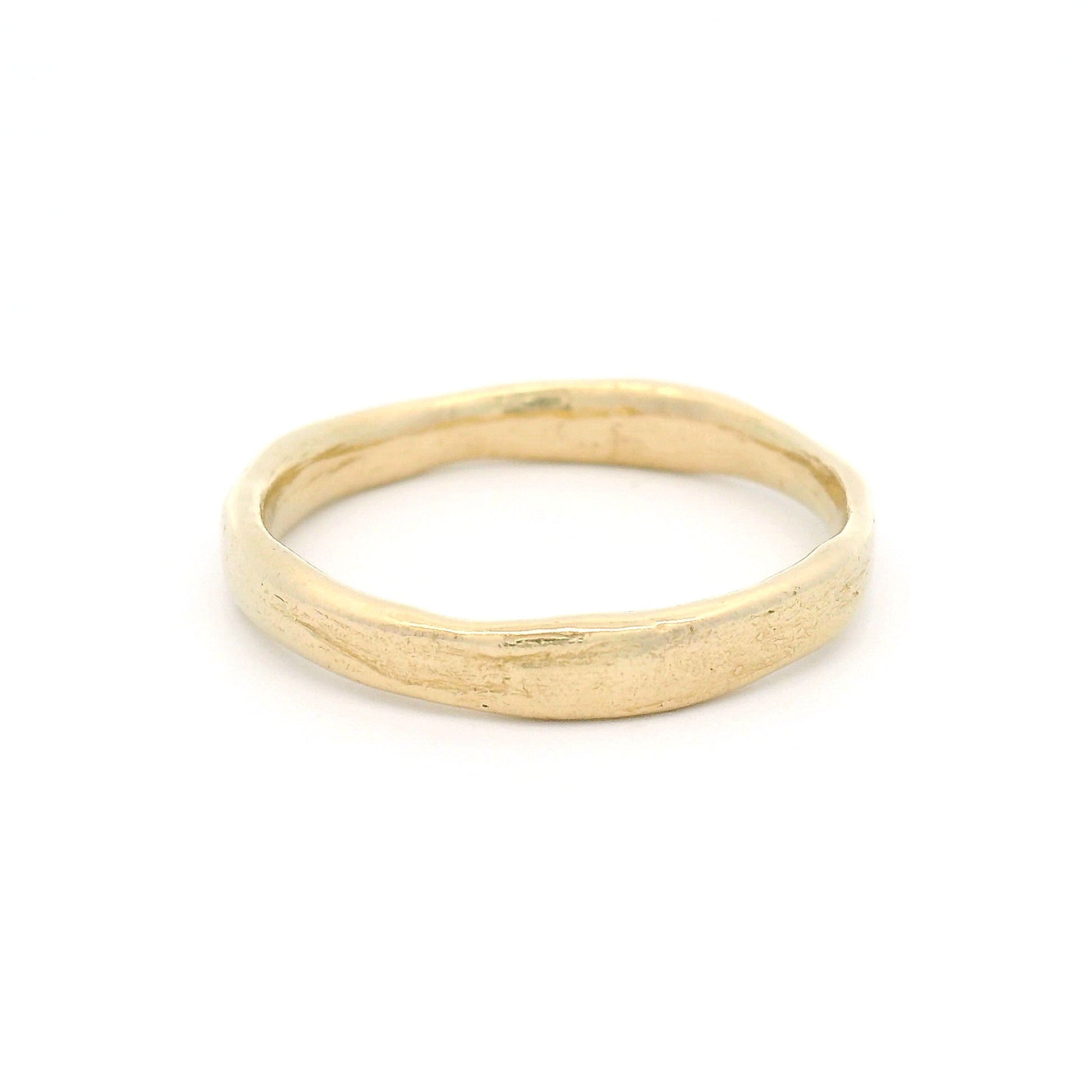 10K yellow gold 3.5mm wedding band featuring a soft organic texture, gently domed profile, and polished comfort-fit interior.