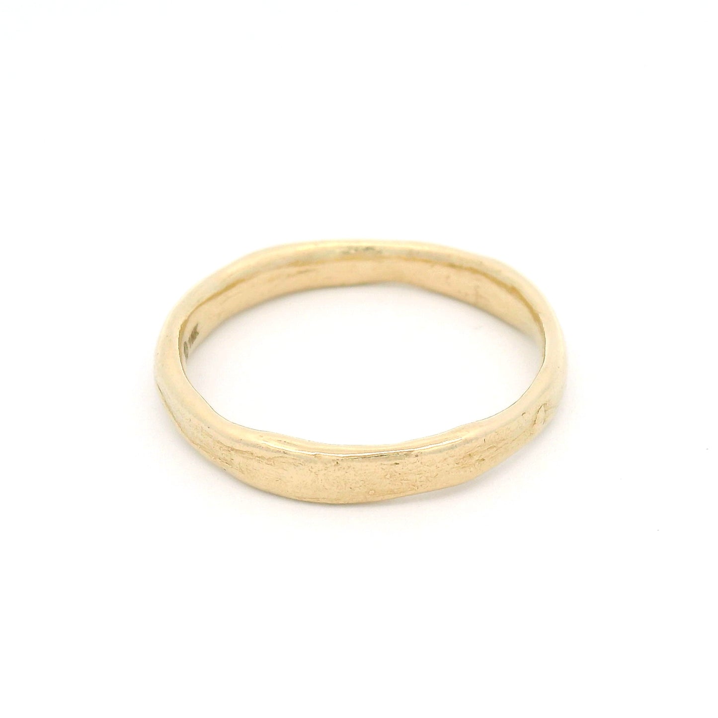 10K yellow gold 3.5mm wedding band featuring a soft organic texture, gently domed profile, and polished comfort-fit interior.