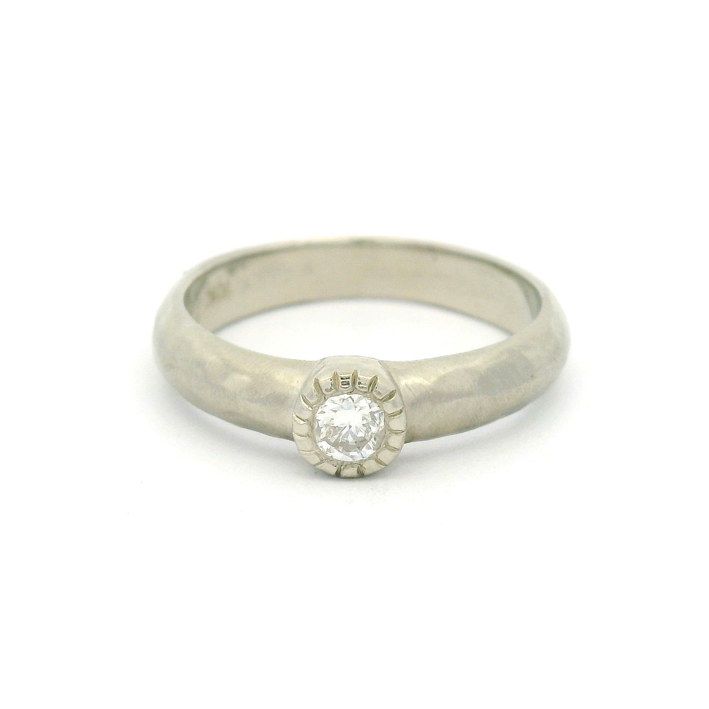 10K white gold organic sculpted solitaire ring with bezel-set 0.18ct round brilliant-cut diamond and milgrain-detailed bezel.