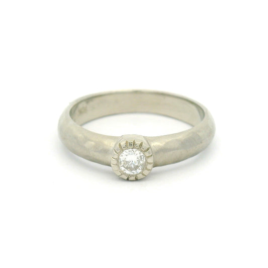 10K white gold organic sculpted solitaire ring with bezel-set 0.18ct round brilliant-cut diamond and milgrain-detailed bezel.
