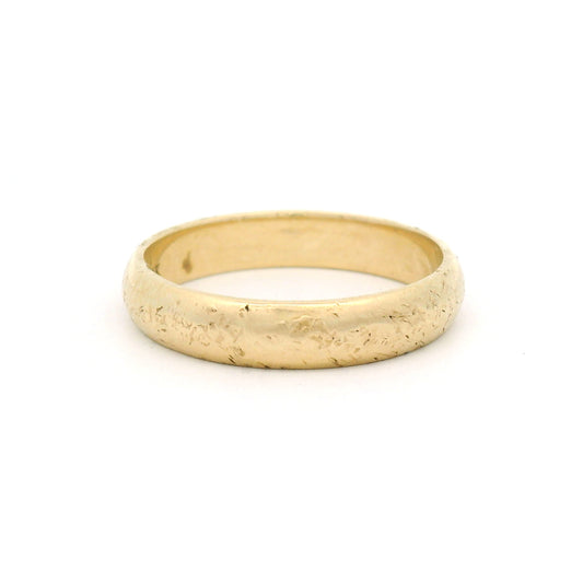 10K yellow gold 4mm wedding band featuring a softly domed profile, straight edges and a rough organic textured finish.