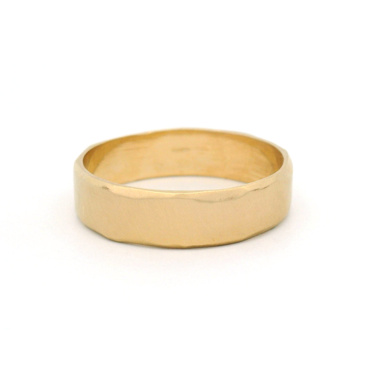 10K yellow gold 5.5mm wedding band with gently wavy bevelled edges, an organic brushed texture and a softly sculpted profile.
