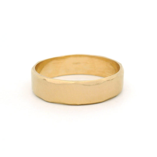 10K yellow gold 5.5mm wedding band with gently wavy bevelled edges, an organic brushed texture and a softly sculpted profile.