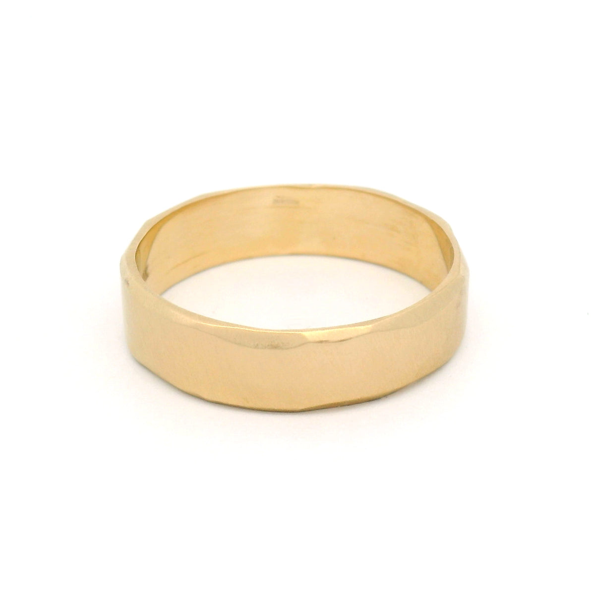10K yellow gold 5.5mm wedding band with gently wavy bevelled edges, an organic brushed texture and a softly sculpted profile.