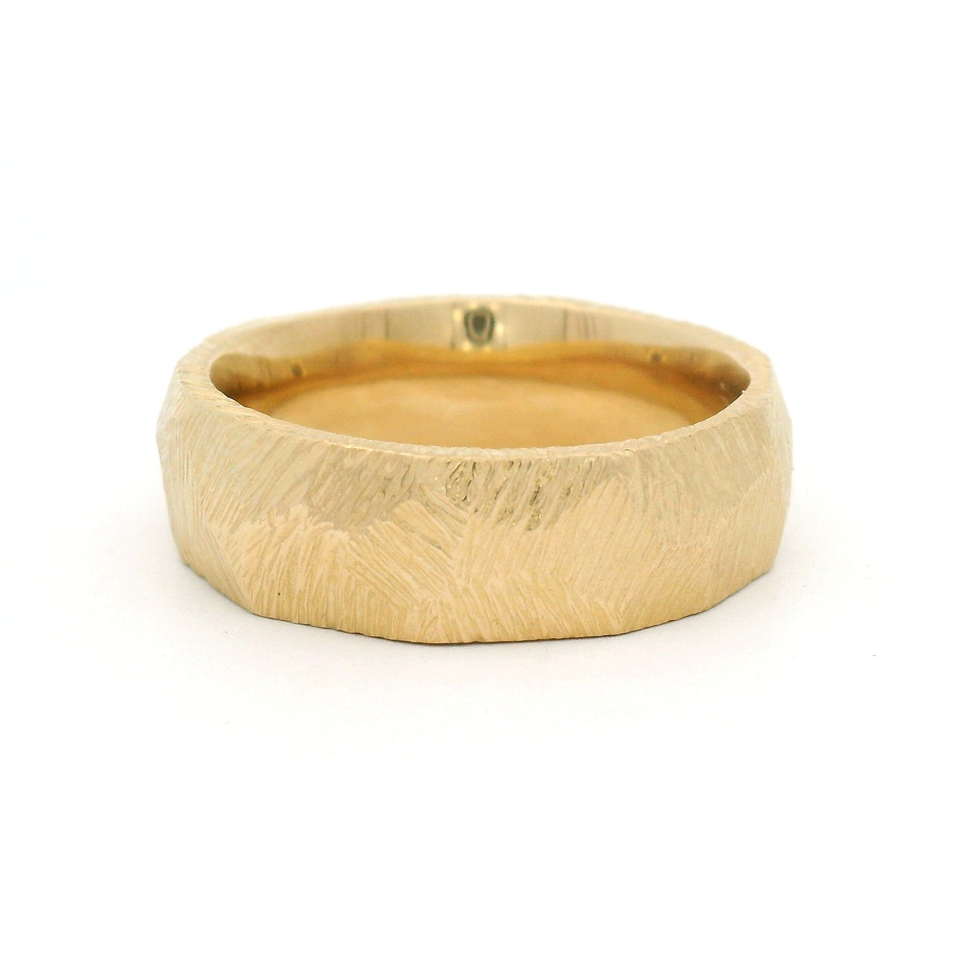 14K yellow gold 7mm textured faceted wedding band with a geometric faceted exterior and polished comfort-fit interior.