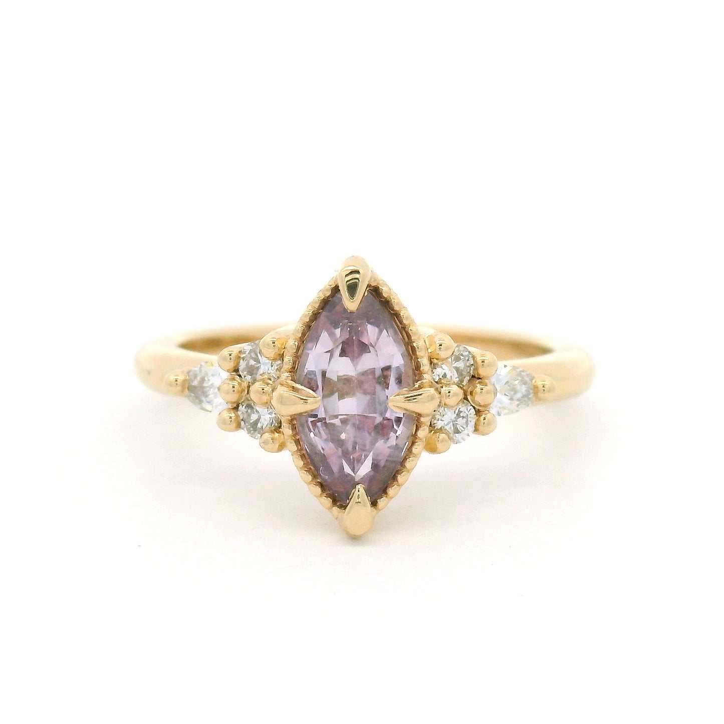 14K yellow gold engagement ring featuring a claw-set natural 1.20ct pink marquise sapphire with four round brilliant-cut and two pear-shaped lab-grown diamond accents totalling 0.19cts.