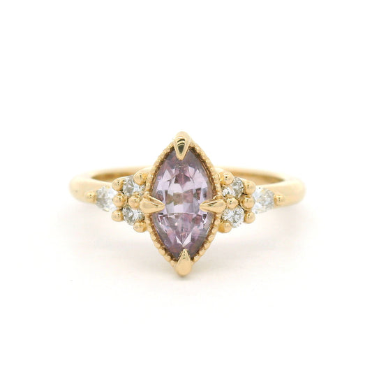 14K yellow gold engagement ring featuring a claw-set natural 1.20ct pink marquise sapphire with four round brilliant-cut and two pear-shaped lab-grown diamond accents totalling 0.19cts.