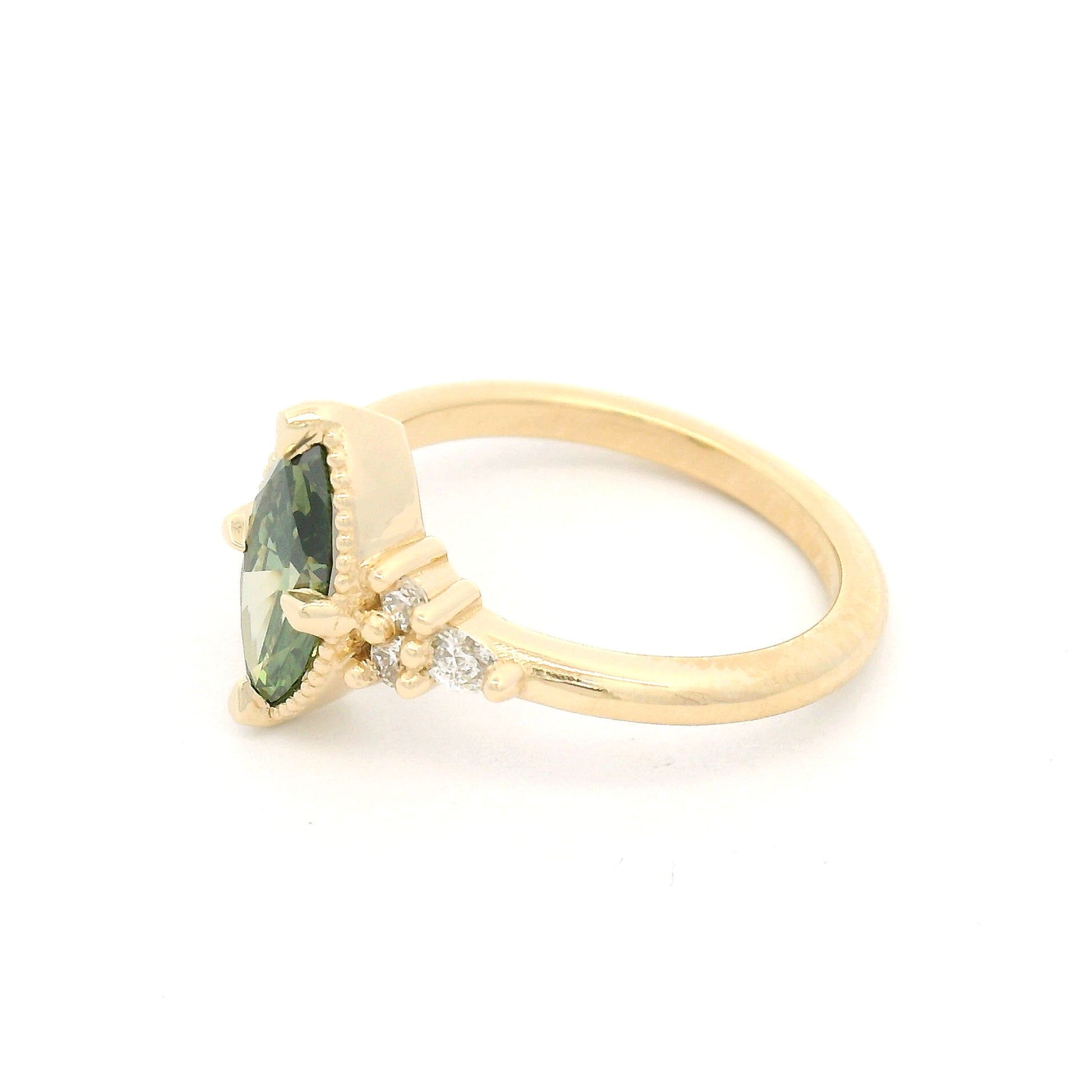 14K yellow gold engagement ring featuring a claw-set 1.01ct lab-grown Fancy Vivid Green marquise diamond with a milgrain edge and six lab-grown diamond accents totalling 0.19cts.