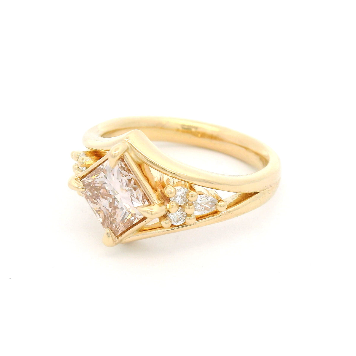 14K yellow gold engagement ring featuring a 1.49ct lab-grown Fancy Pink Brownish princess-cut diamond in a kite orientation, split shank, and 0.19cts of lab-grown diamond accents.
