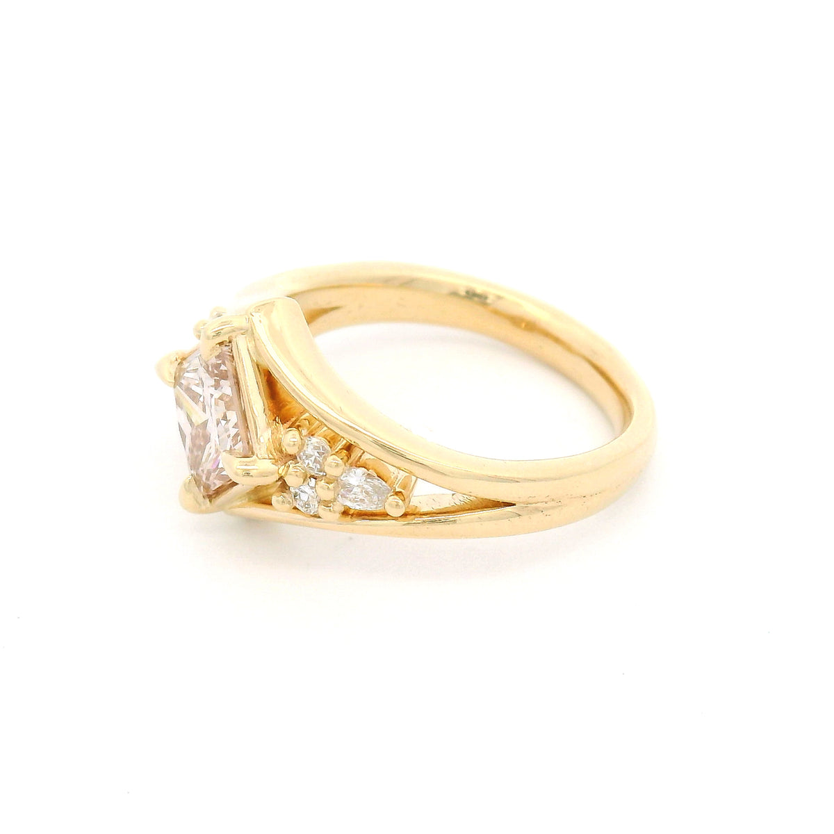 14K yellow gold engagement ring featuring a 1.49ct lab-grown Fancy Pink Brownish princess-cut diamond in a kite orientation, split shank, and 0.19cts of lab-grown diamond accents.