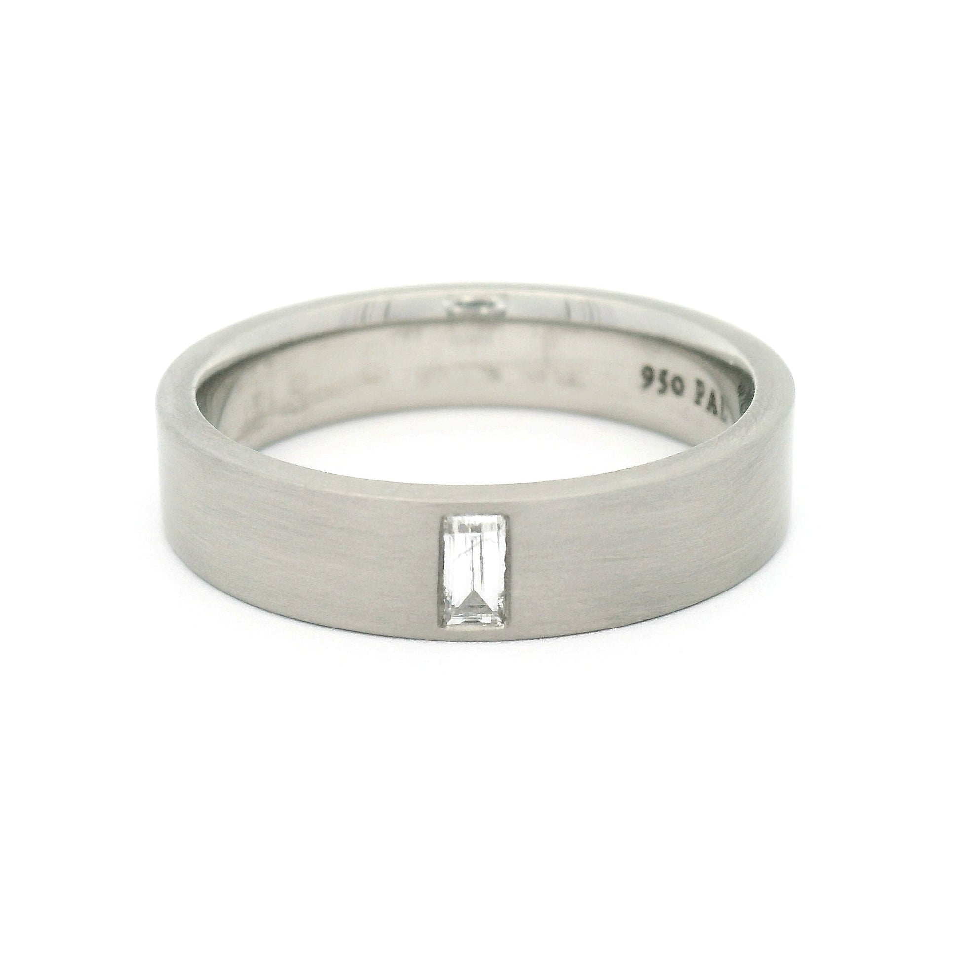 5mm 950 palladium comfort-fit band with a flat brushed finish and flush-set 0.12ct lab-grown baguette-cut diamond.