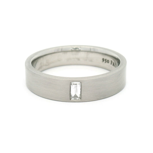 5mm 950 palladium comfort-fit band with a flat brushed finish and flush-set 0.12ct lab-grown baguette-cut diamond.