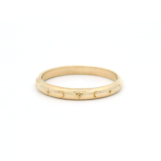 10K yellow gold 2.5mm soft dome band hand-engraved with alternating star and crescent moon motifs.