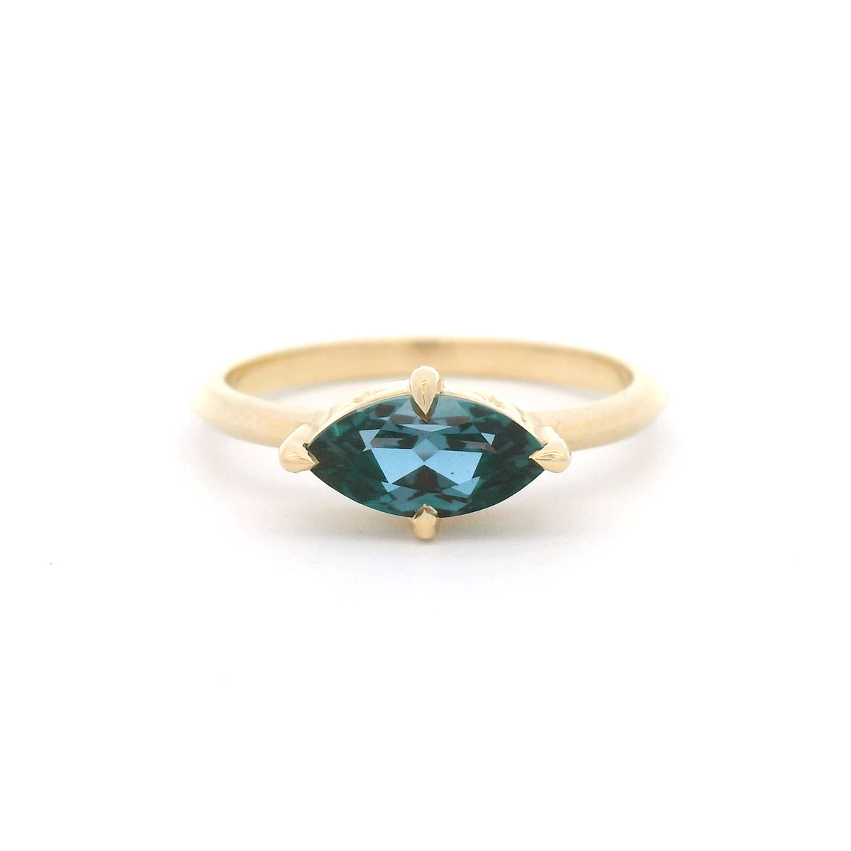 10K yellow gold solitaire engagement ring with a claw-set 1.00ct lab-grown alexandrite, 1.8mm knife-edge band and engraved star undergallery.