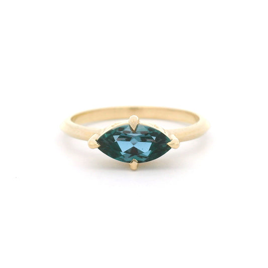 10K yellow gold solitaire engagement ring with a claw-set 1.00ct lab-grown alexandrite, 1.8mm knife-edge band and engraved star undergallery.