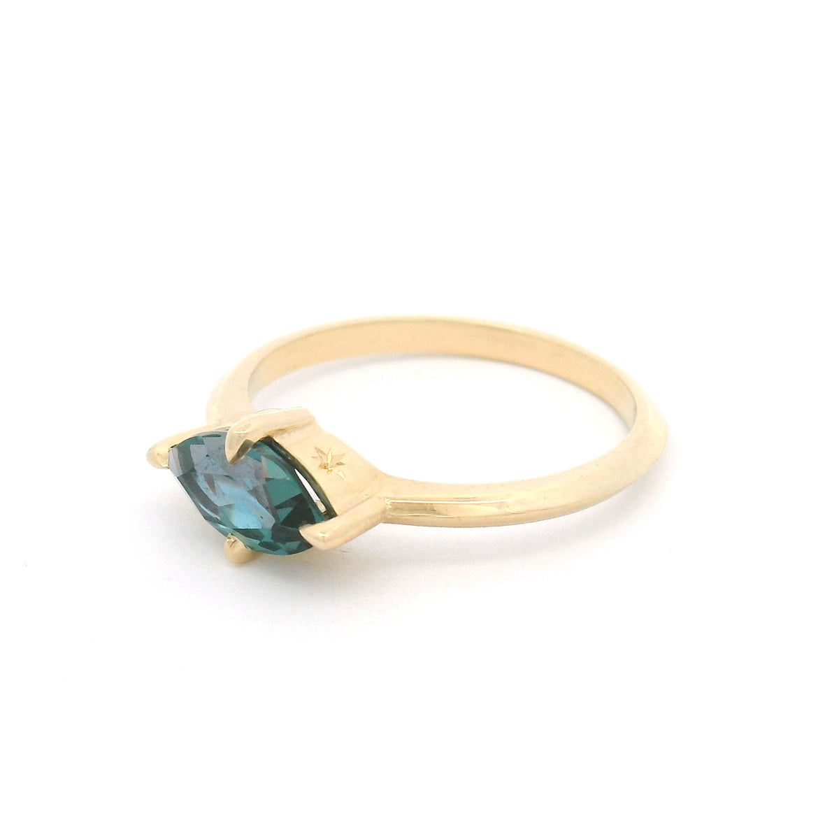 10K yellow gold solitaire engagement ring with a claw-set 1.00ct lab-grown alexandrite, 1.8mm knife-edge band and engraved star undergallery.