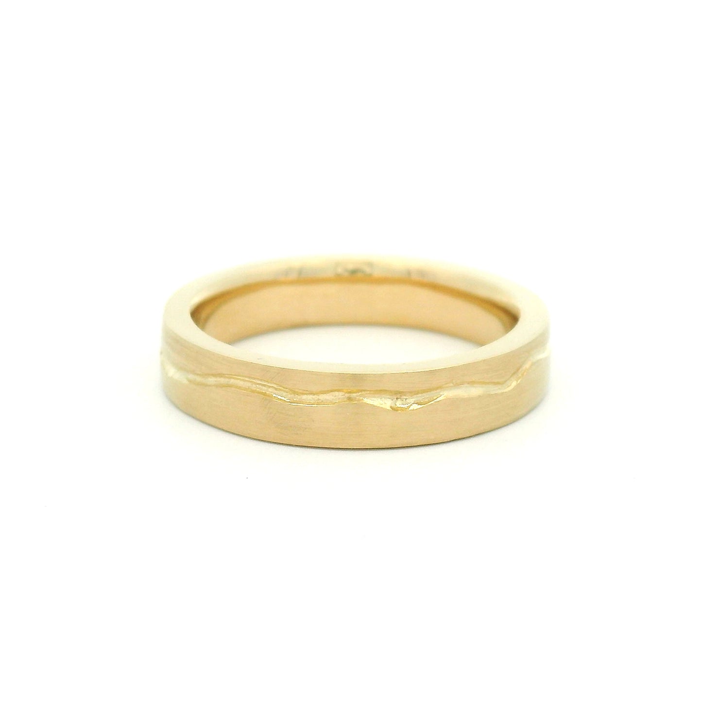 10K yellow gold 4mm wedding band with a soft flat profile, satin finish, comfort-fit interior, and delicate wandering cut path wrapping the band.