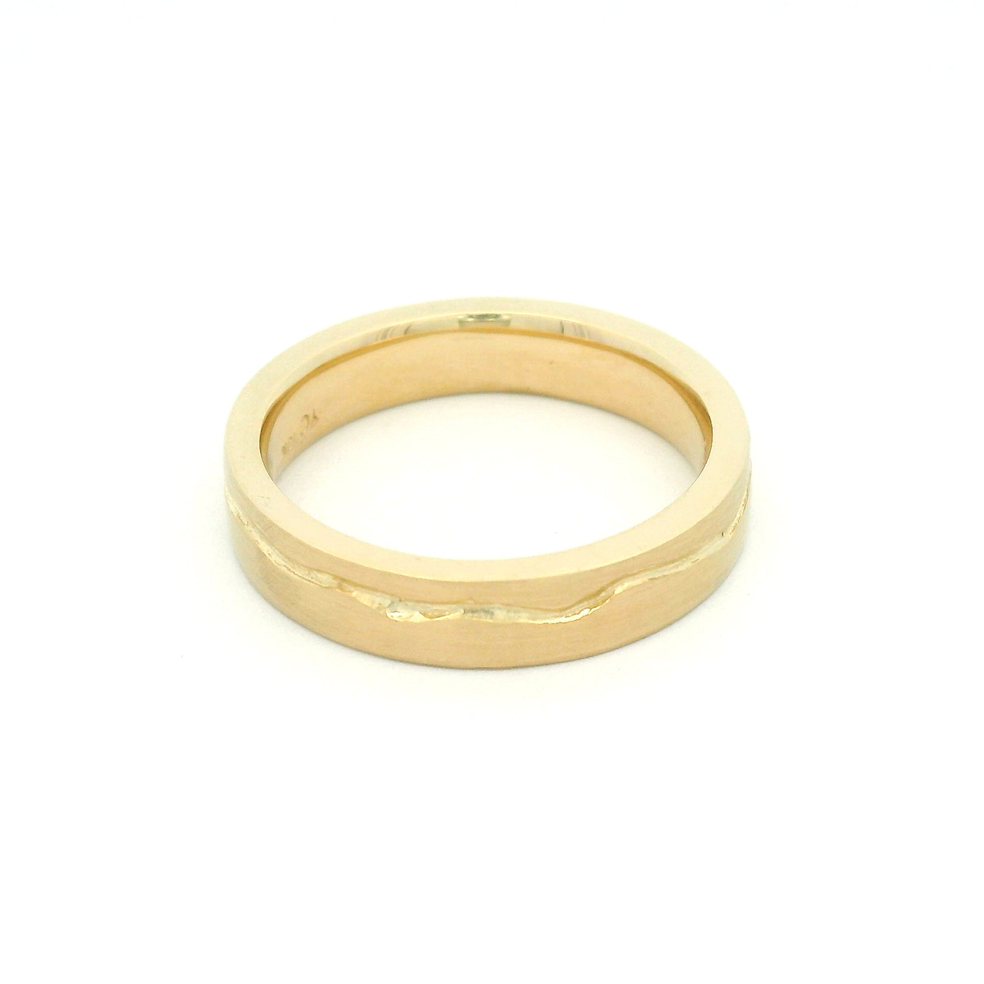 10K yellow gold 4mm wedding band with a soft flat profile, satin finish, comfort-fit interior, and delicate wandering cut path wrapping the band.