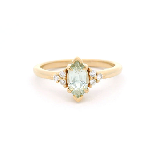 14K yellow gold claw-set engagement ring with a 0.83ct marquise light-green sapphire and six round brilliant-cut lab-grown diamond accents.