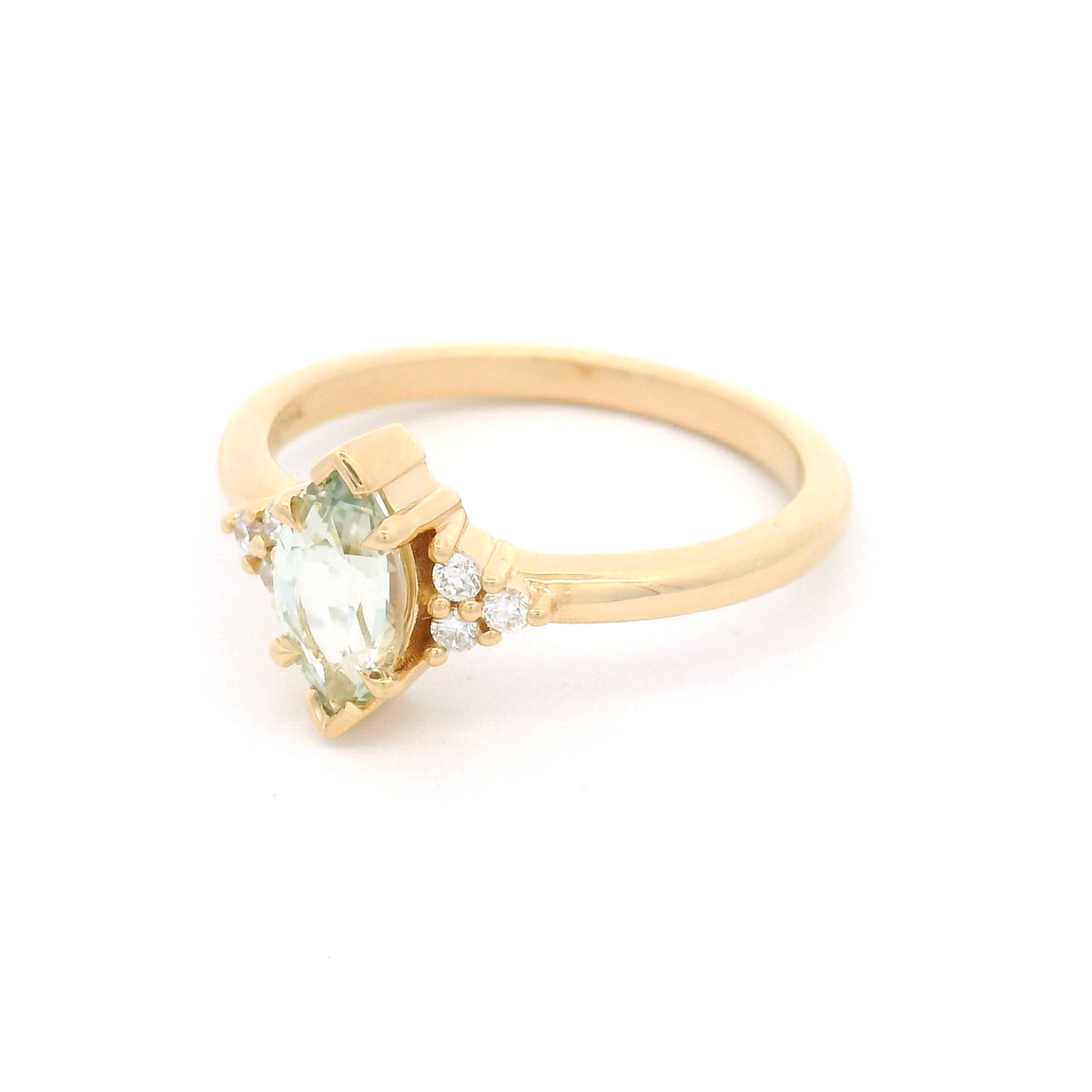 14K yellow gold claw-set engagement ring with a 0.83ct marquise light-green sapphire and six round brilliant-cut lab-grown diamond accents.