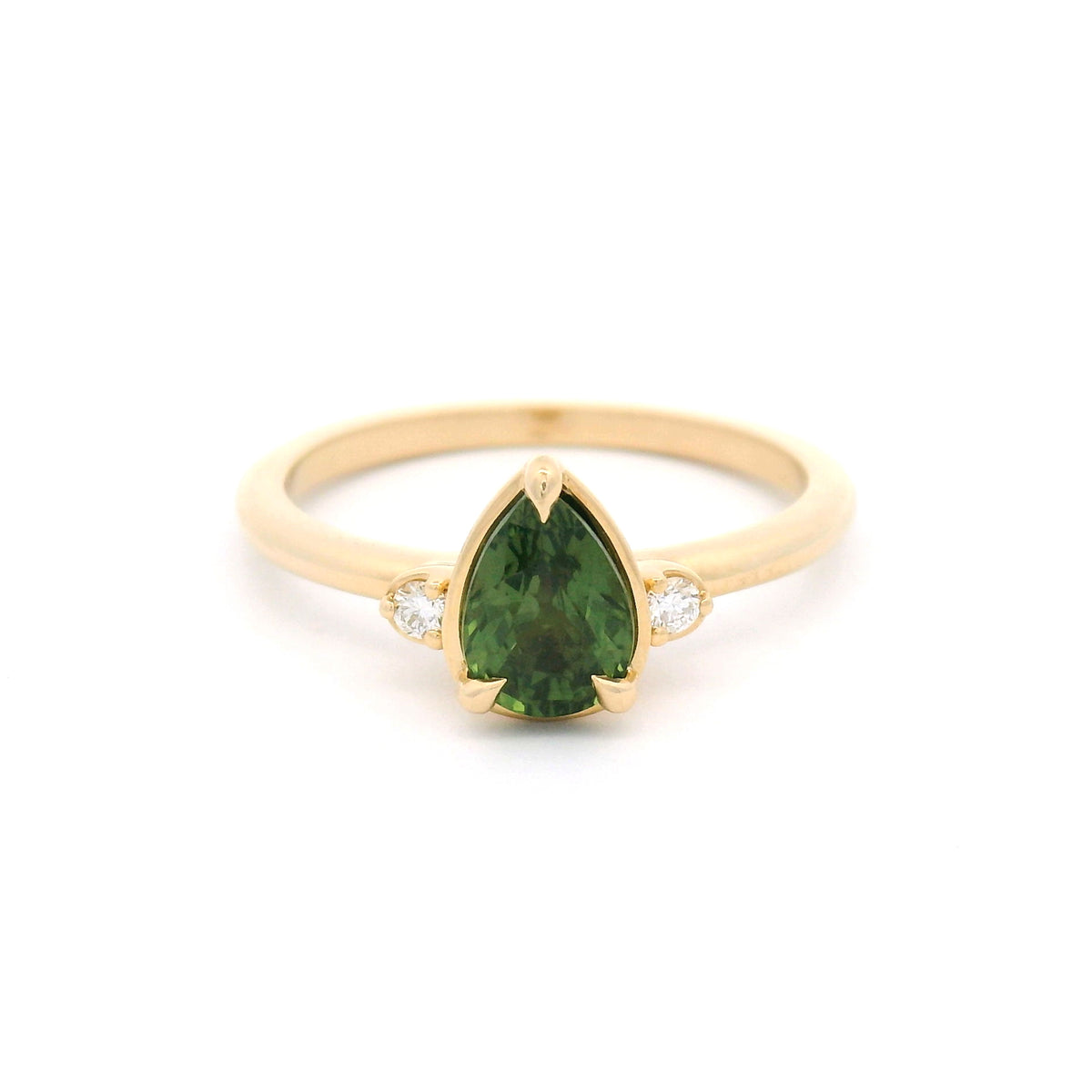 14K yellow gold claw-set three-stone ring with a 1.09ct pear-cut Madagascar green sapphire and two round lab-grown diamond accents.