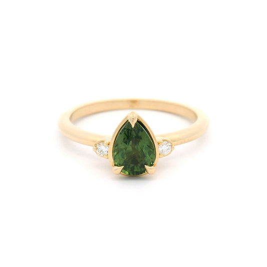14K yellow gold claw-set three-stone ring with a 1.09ct pear-cut Madagascar green sapphire and two round lab-grown diamond accents.