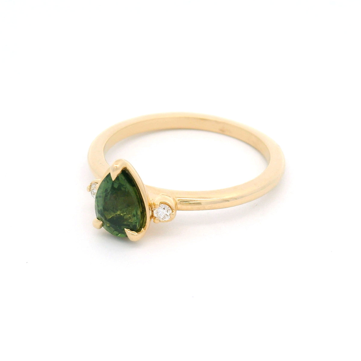 14K yellow gold claw-set three-stone ring with a 1.09ct pear-cut Madagascar green sapphire and two round lab-grown diamond accents.