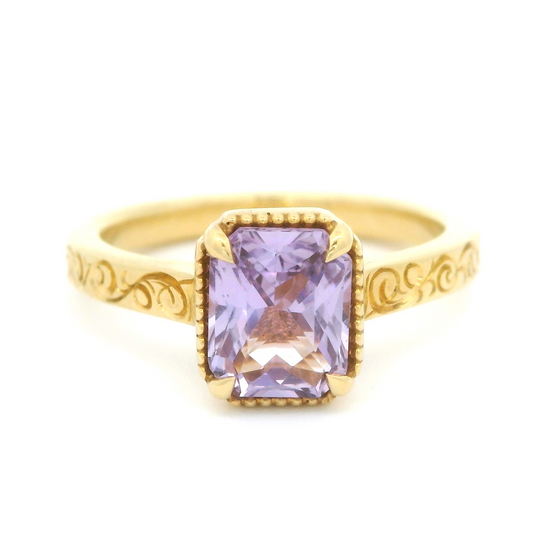 Video of 18k yellow gold ring with 1.63ct lavender sapphire and hand engraving.